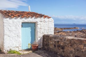 Small white building next to water