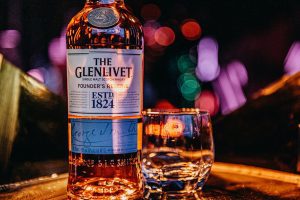 a bottle of whisky and a glass