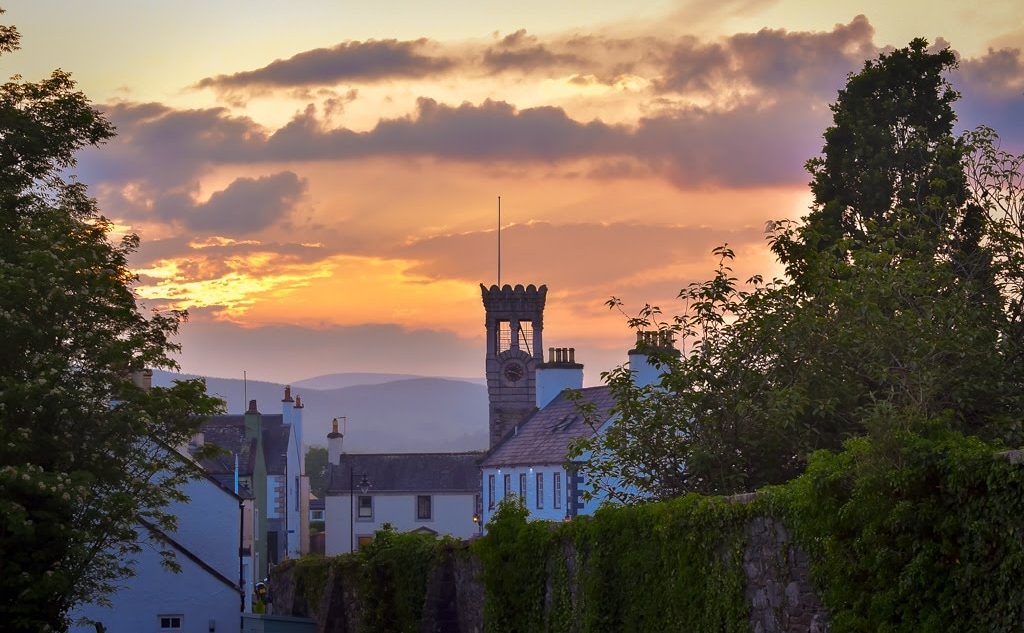 Sunset with a tower in the distance in a little village